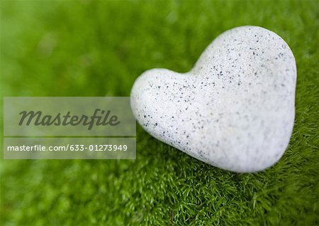 Heart shaped stone on moss