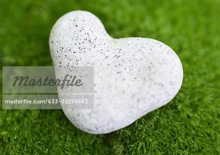 Heart-shaped stone on moss