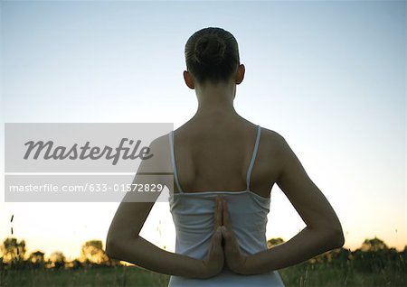 Woman doing yoga pose with prayer hands behind back - a Royalty Free Stock  Photo from Photocase