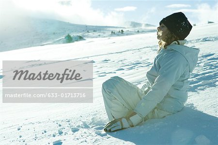 Teen girl sitting on snow