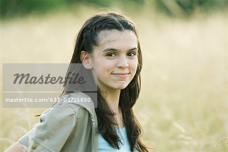 Teen girl in field, portrait