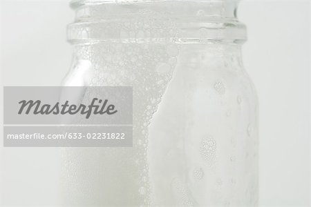 Glass jar with soap suds, close-up