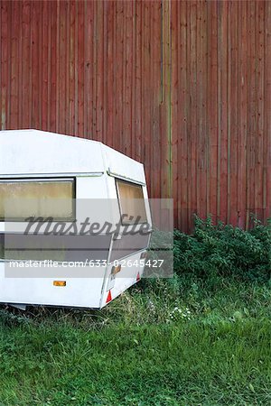 Abandoned camper in field, cropped