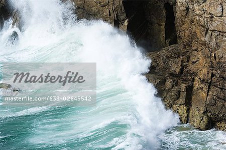 Waves crashing against cliff side, close-up
