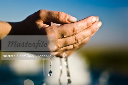 Water flowing from cupped hands