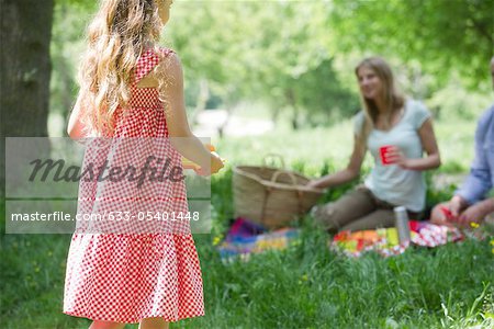 Little girl having picnic with family