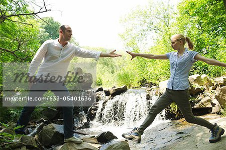 Couple hiking, woman reaching for man's hand