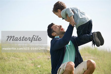 Father and young son playing outdoors
