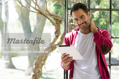 Man using digital tablet at home