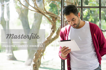 Man using digital tablet at home