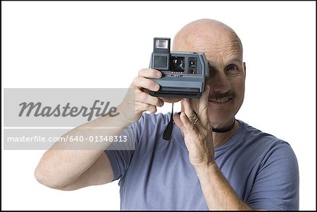 Portrait of a mature man taking a photograph