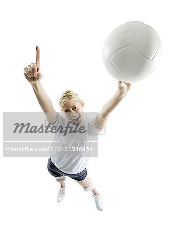 Portrait of a young woman holding up a volleyball