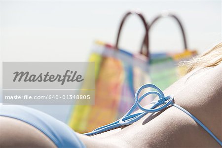 Close-up of a young woman sunbathing on the beach