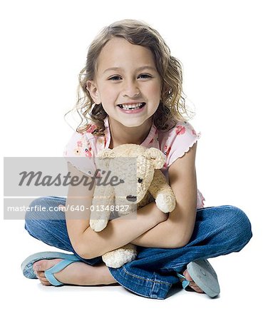 Portrait of a girl hugging a teddy bear