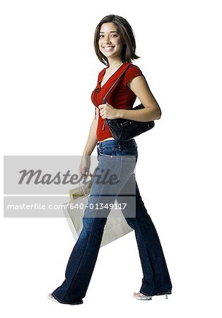 Portrait of a young woman carrying shopping bags