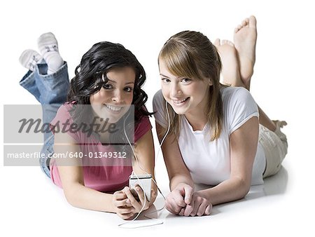 Portrait of two girls listening to music on an MP3 player