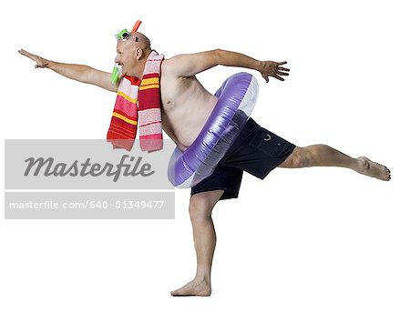 Man standing on one leg with an inflatable ring around his waist