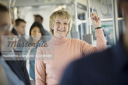 Portrait of a mature woman standing in a passenger train
