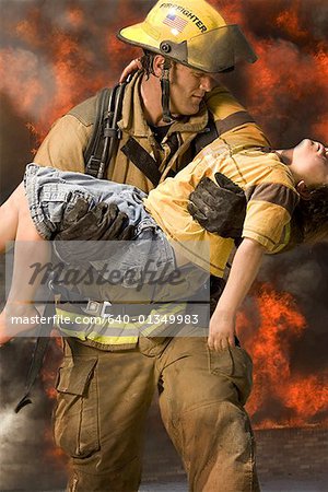 Firefighter carrying an injured boy
