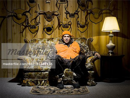 Man on sofa with antlers