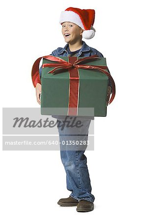 Portrait of a boy holding a Christmas present
