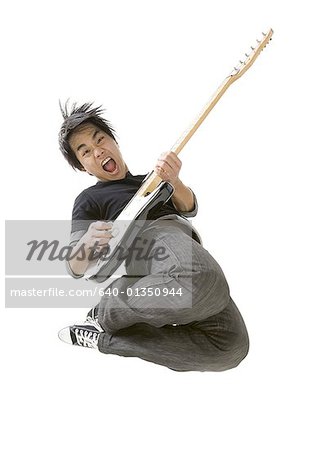 Portrait of a young man playing a guitar