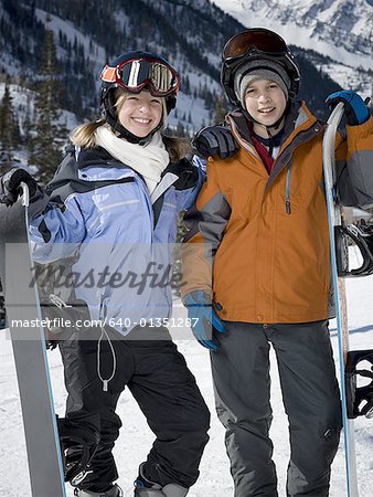 Portrait of a boy and his sister smiling