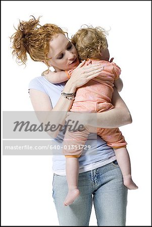 Close-up of a young woman hugging her daughter