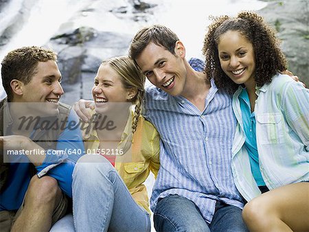 Close-up of two young women and two young men smiling