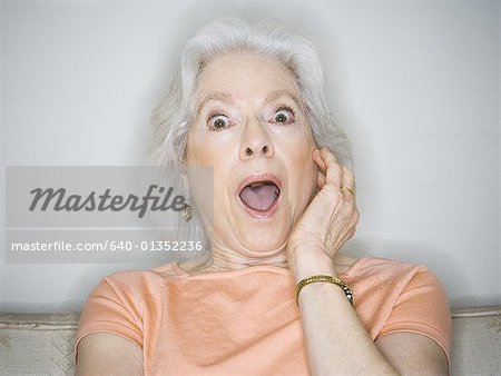 Close-up of a senior woman with her mouth open - Stock Photo