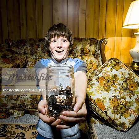 Boy with coin jar smiling