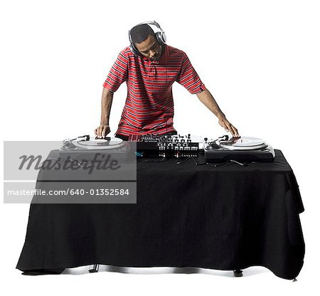 DJ with headphones spinning records DJ with headphones spinning records