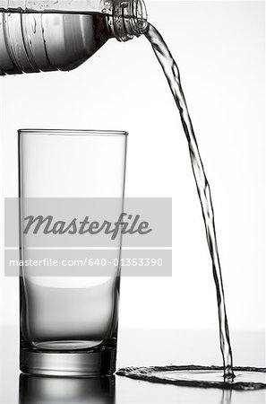 Close-up of water being poured outside of a glass