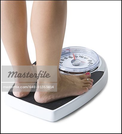 Feet standing on a bathroom scale