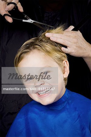 Boy having his hair cut smiling