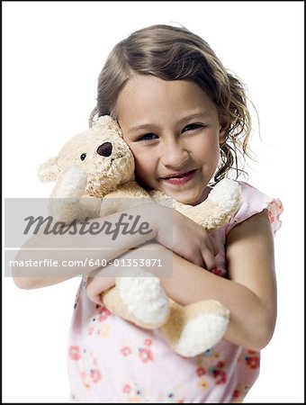 Portrait of a girl hugging a teddy bear