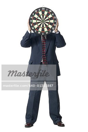 Man with dartboard hiding face