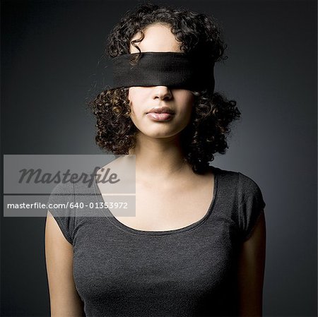 Woman blindfolded, smiling - Stock Image - F003/3209 - Science Photo Library