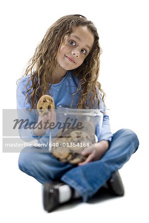 Portrait of a girl holding a jar of cookies