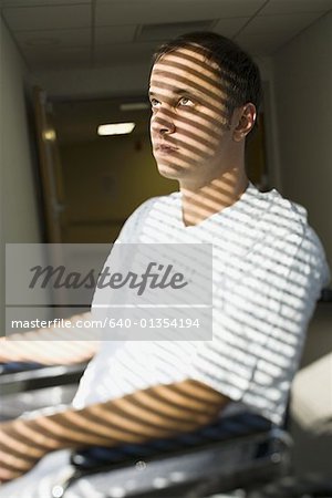 Close-up of a patient sitting on a wheelchair and thinking