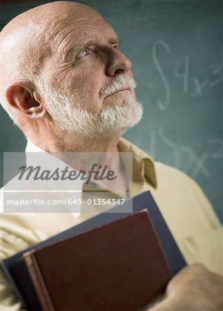 Close-up of a senior male professor carrying diaries