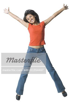 Portrait of a young woman jumping