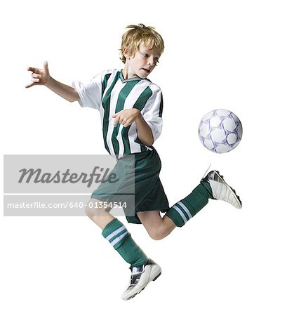 Young boy kicking a soccer ball