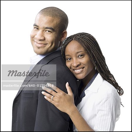 Portrait of a young man smiling with a young woman