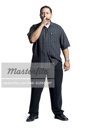Portrait of a mid adult man smoking a cigar
