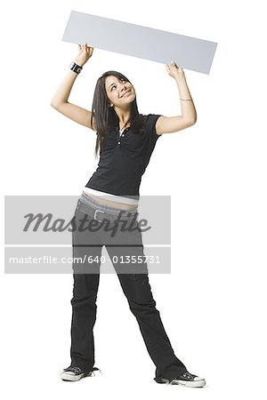 Young woman holding up a blank sign