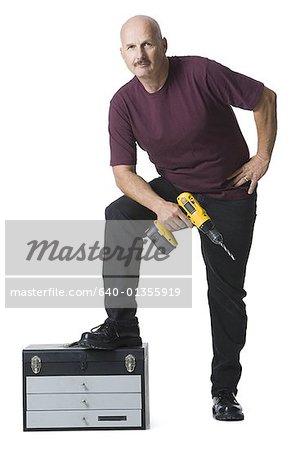 Portrait of a man holding an electric drill