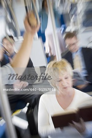 High angle view of a group of people in a passenger train High angle view of a group of people in a passenger train