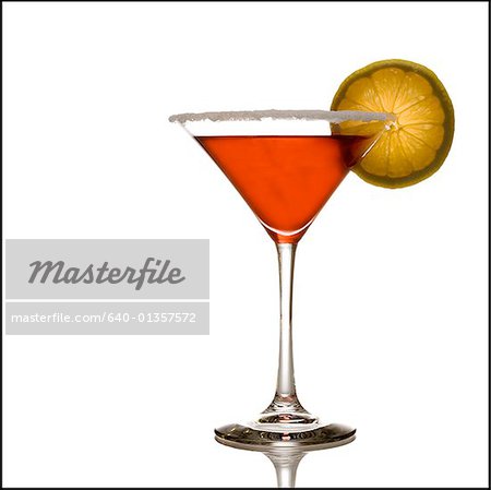 Red beverage in martini glass with lemon slice