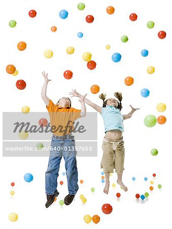 A boy and a girl playing with colored balls